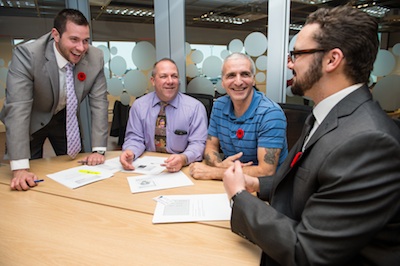 MBA students Elliot Thompson (extreme left) and Zachary Robson (extreme right), consulting with two retiring members of the Canadian Armed Forces on their business plans.