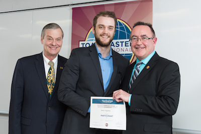 Duncan McCormick (centre) receives the Speechcraft certificate from then Mayor of Fredericton Brad Woodside (L) and Toastmasters International President Jim Kokocki (R).