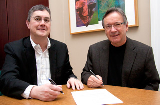 UNB President Eddy Campbell (left) and Barry G. Bisson, President of Shad Valley International sign the MOU. UNB photo. 