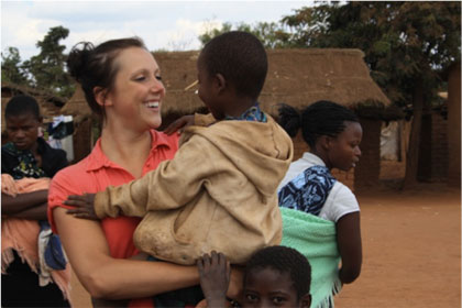 Melissa Foster (KIN) plays with children in Kauma Village, where she volunteered with Feed the Children Program.