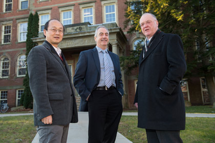 The Honourable Keith Ashfield (right) congratulates UNB's Dr. John Spray (middle) and Dr. Yun Zhang (left). (Rob Blanchard photo)