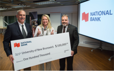 Michael McManus, National Bank’s regional manager for Western New Brunswick and Prince Edward Island, presents UNB's Pond Deshpande Centre with a cheque for $100,000. 