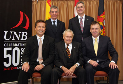 Seated from left to right: Grant Joyce, Ron Joyce and Steven Joyce Standing from left to right:  Dr. Allison McCain, UNB chancellor and Dr. Eddy Campbell, UNB President