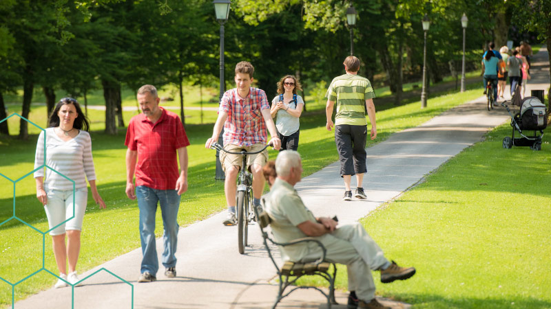 People walking and cycling in a park
