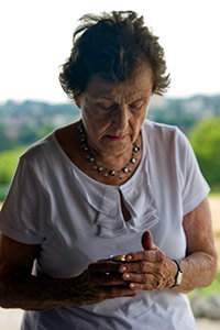 The late Vera Schiff lighting a memorial candle at Majdanek during the March for Life in 2010. (Photo courtesy Michael Rajzman).