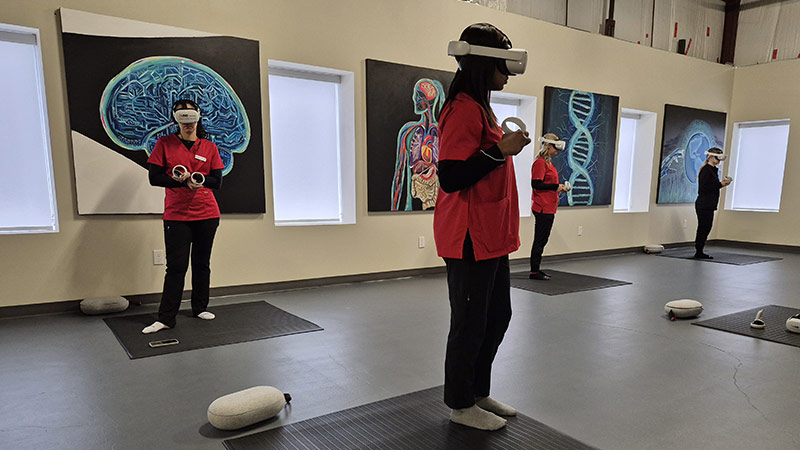 Nursing students at the UNB Moncton site use virtual reality headsets in a simulation.