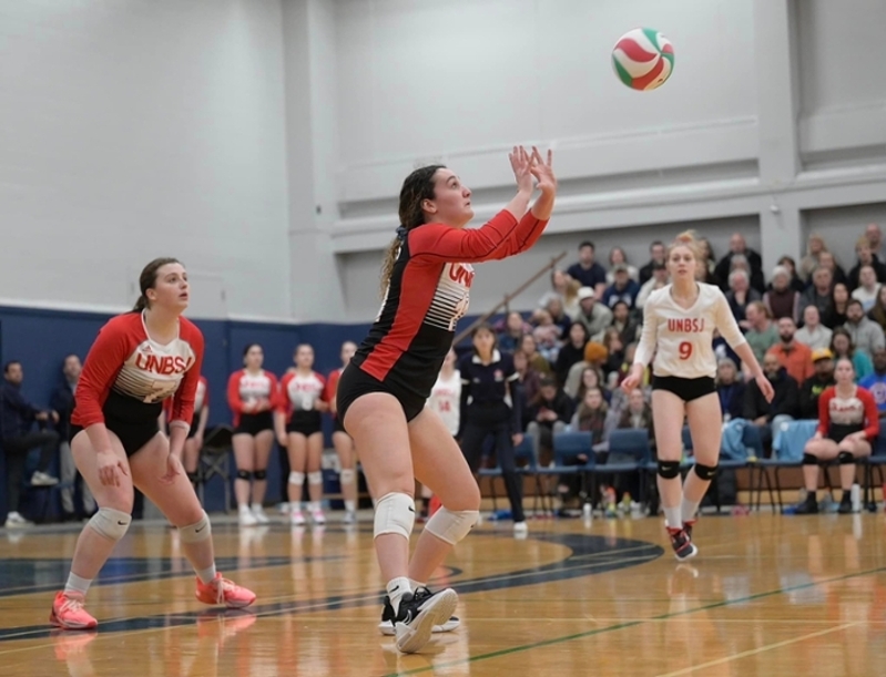Sydney Flower playing defense at the 2022-23 ACAA Volleyball Championships. 