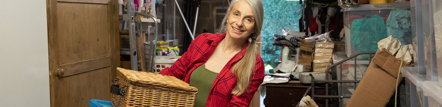 Woman cleaning out a cluttered room