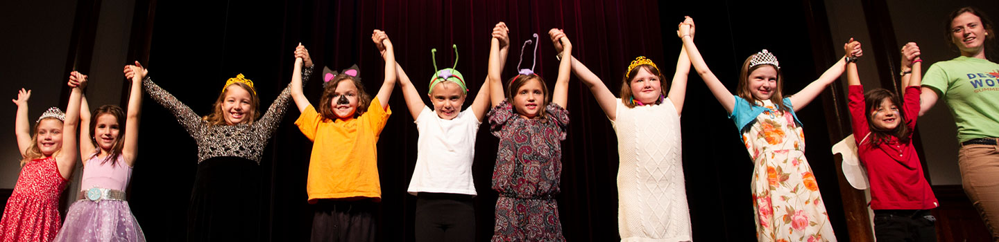 Photograph of a group of kids performing on a stage