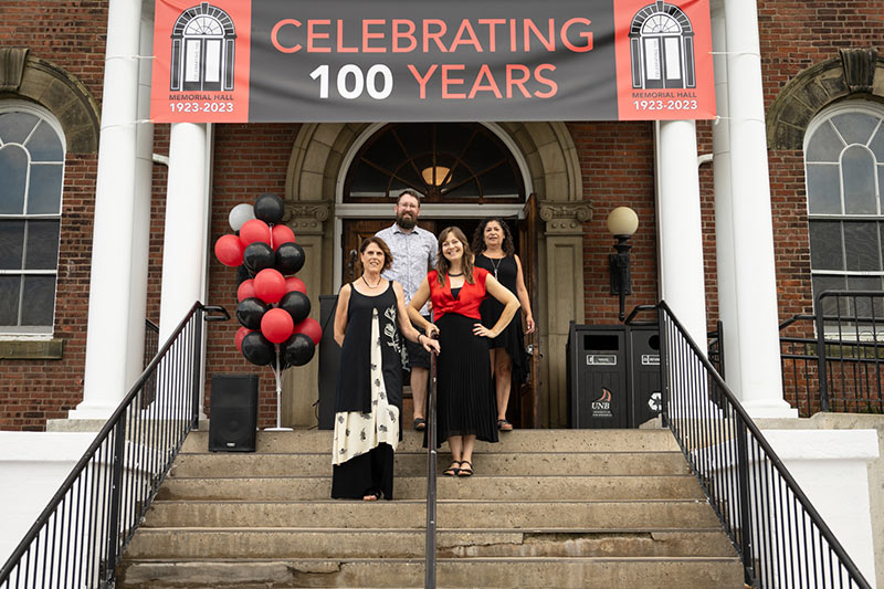 This is a photo of Memorial Hall front steps with UNB Art Centre staff standing on the steps.