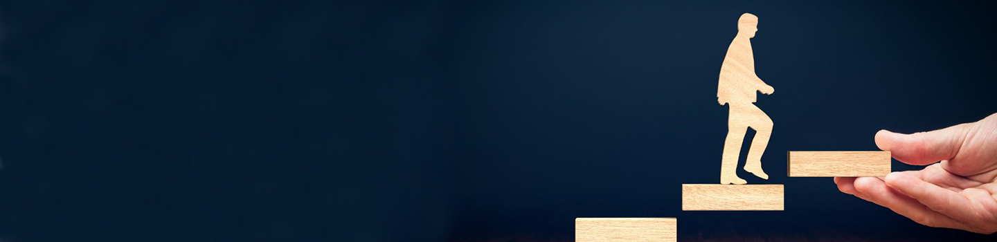 Photograph of wooden person climbing wood staircase