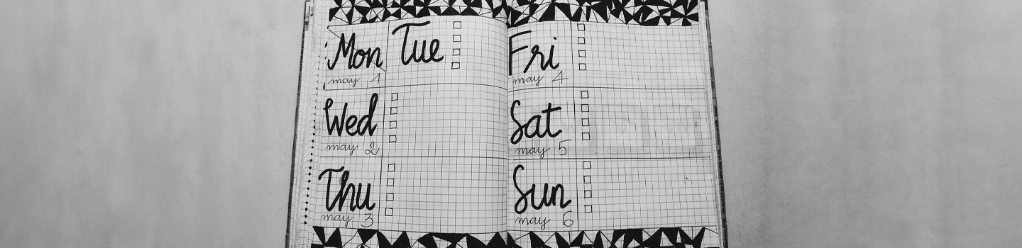 A notebook open to a weekly planner 