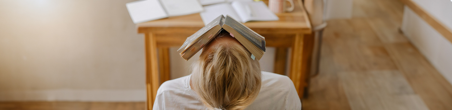 Woman with a book open and resting on her face