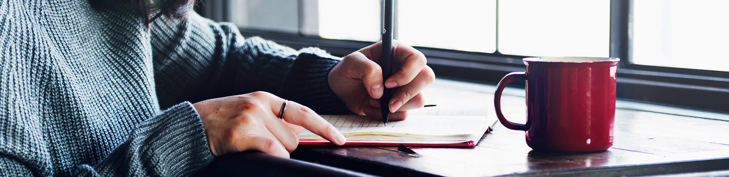 Person writing in a notebook