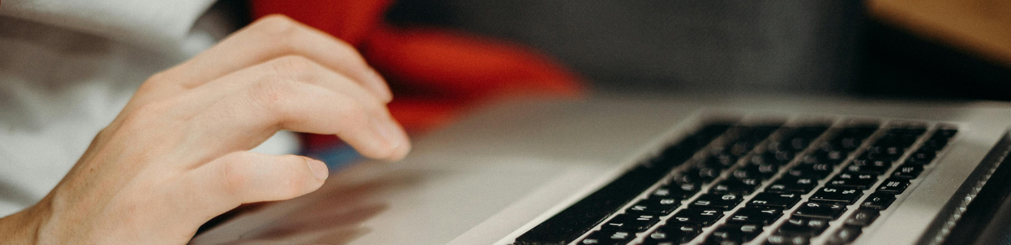 Photograph of a person using a laptop 
