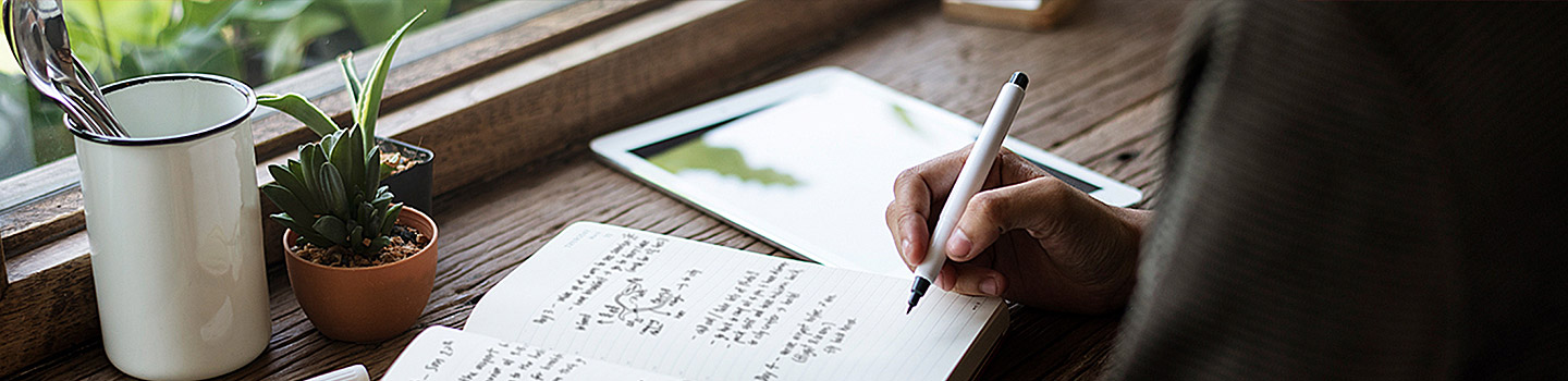Photograph of a notebook on a desk that contains handwritten notes