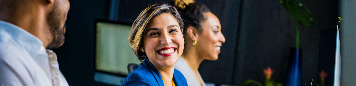 Employees sitting together and smiling
