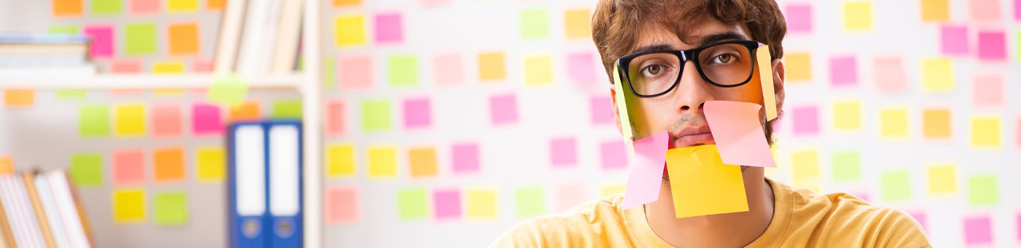Student with sticky notes all over his face and room