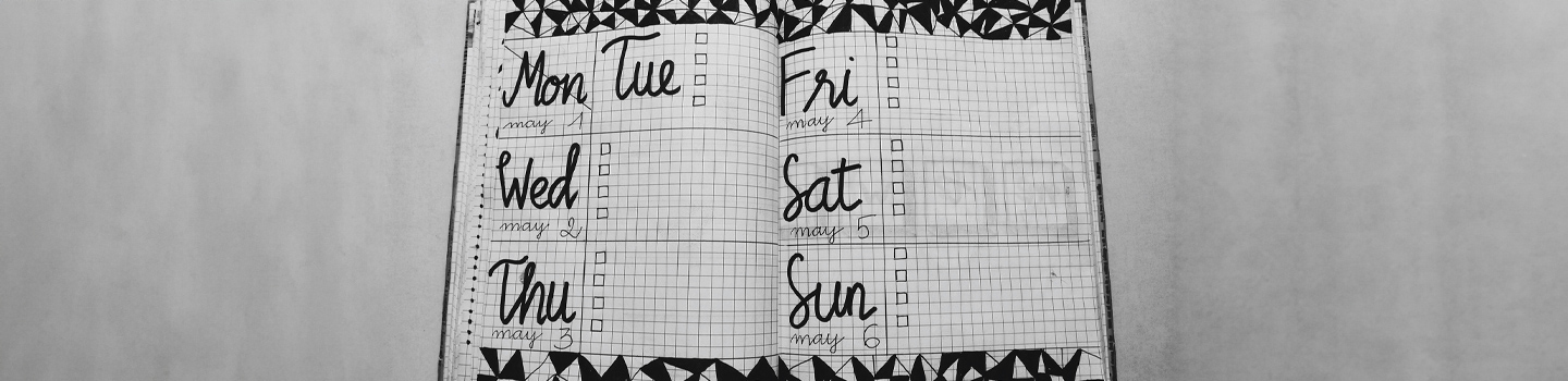 A notebook open to a weekly planner