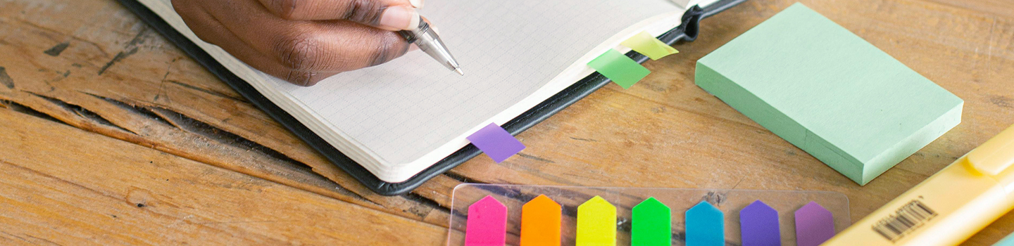 Photograph of a notebook with colourful tabs