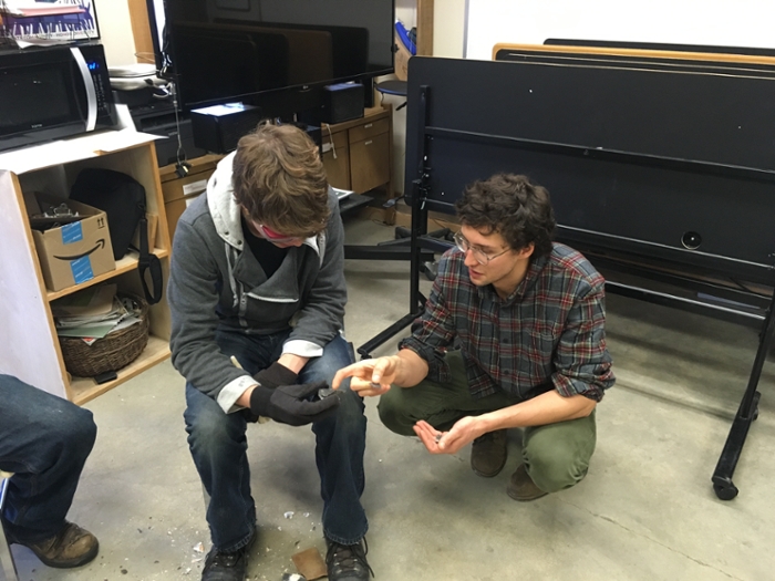 UNB student helps train high school student in flint-knapping