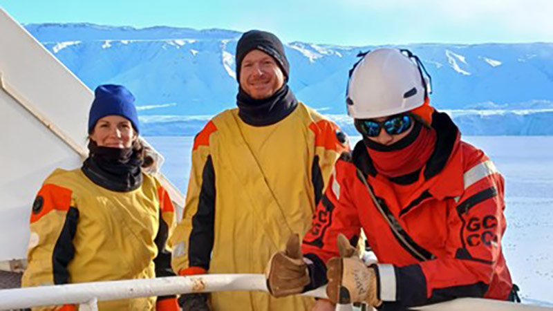 The surface sediment team in our immersion suits, moments before boarding the zodiac for a sampling near the glacier front. From Left to right: Audrey Limoges, Alexandre Normandeau (Researcher, Geological Survey of Canada and Adjunct Professor in the department of Earth Sciences at UNB), Alexis Brault (third officer, Canadian Coast Guard). Photo: Julie Marcoux.