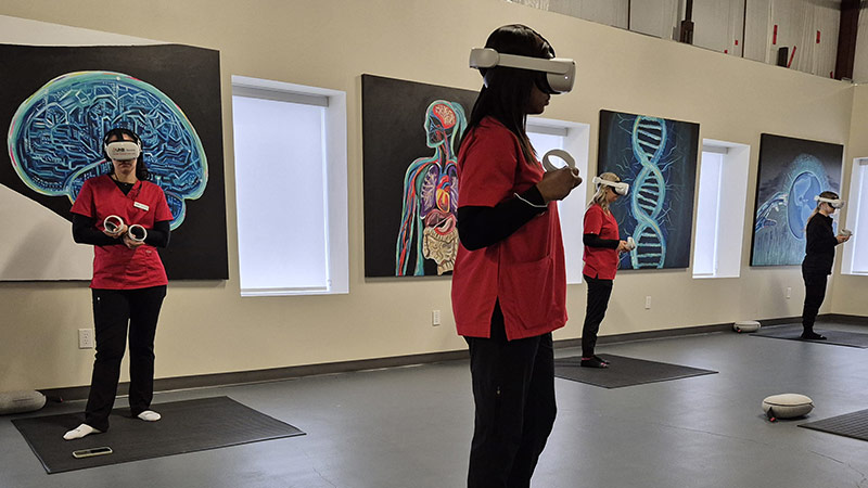 Students work with virtual reality headsets.