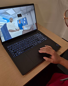 A student works on a laptop, which shows what students see when using virtual reality headsets.