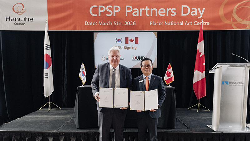 Dr. Paul J. Mazerolle, UNB president and vice chancellor, left, and Charlie SC Eoh, the president and COO of Naval Ship Business for Hanwha Ocean, after signing the MOU in Ottawa on March 5.