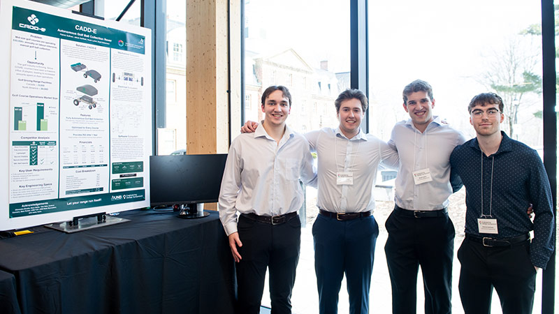 From left, Jakob Ashfield, Brett Melanson, Noah Lydon and Patrick Sullivan developed an autonomous, battery‑powered golf ball collection rover named CADD-E to make automation affordable for small‑ and mid‑sized golf courses.
